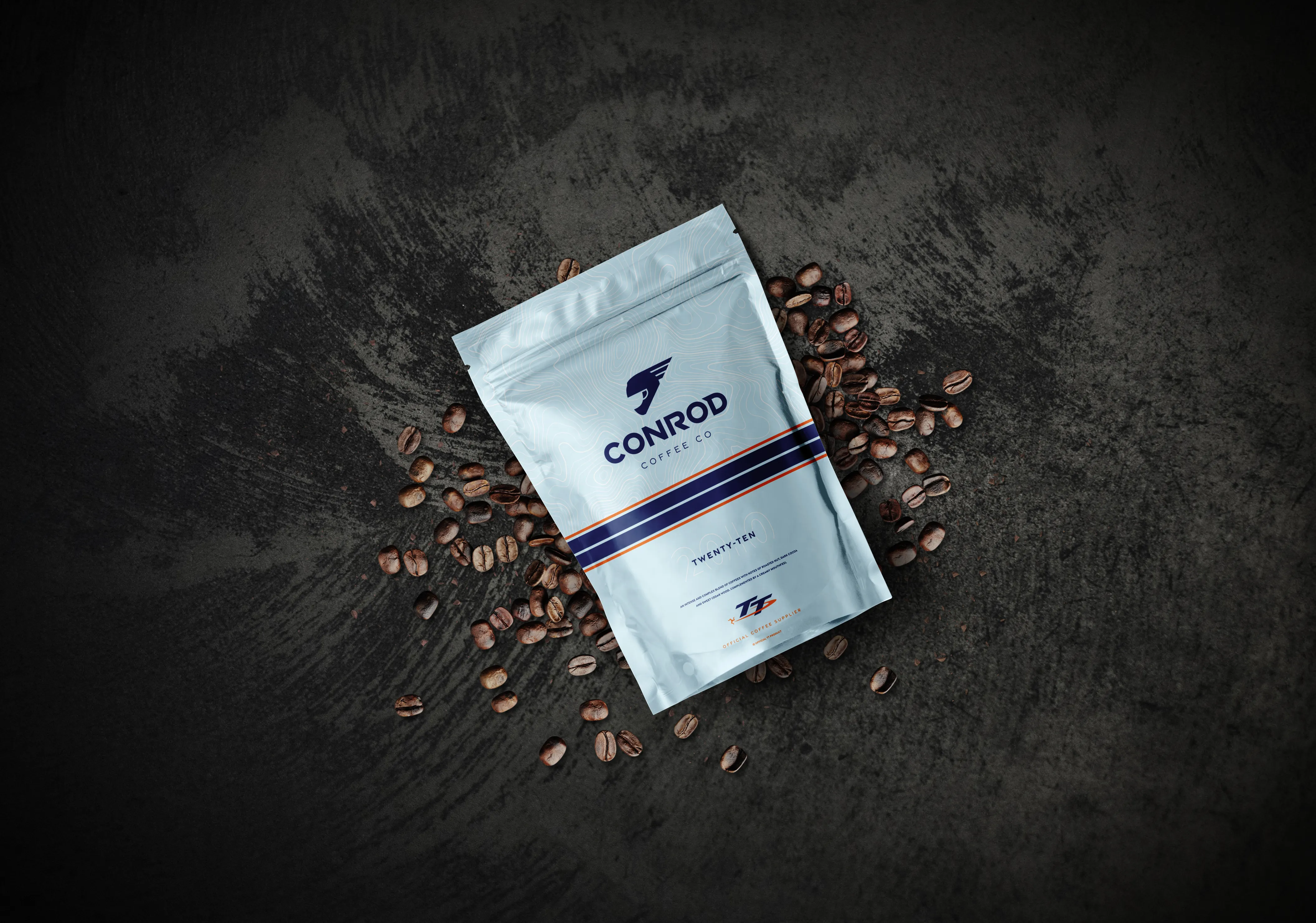 Conrod Coffee Co Twenty-Ten blend coffee bag surrounded by coffee beans, photographed by DotPerformance for the Conrod Coffee Co website and e-commerce store